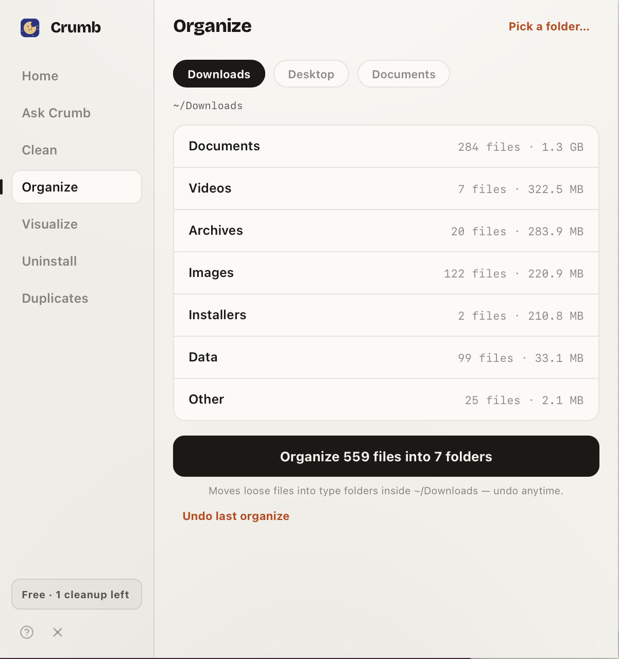 Crumb's Organize view sorting a Downloads folder into type categories — Documents, Videos, Archives, Images and more — with an Organize 559 files into 7 folders button.